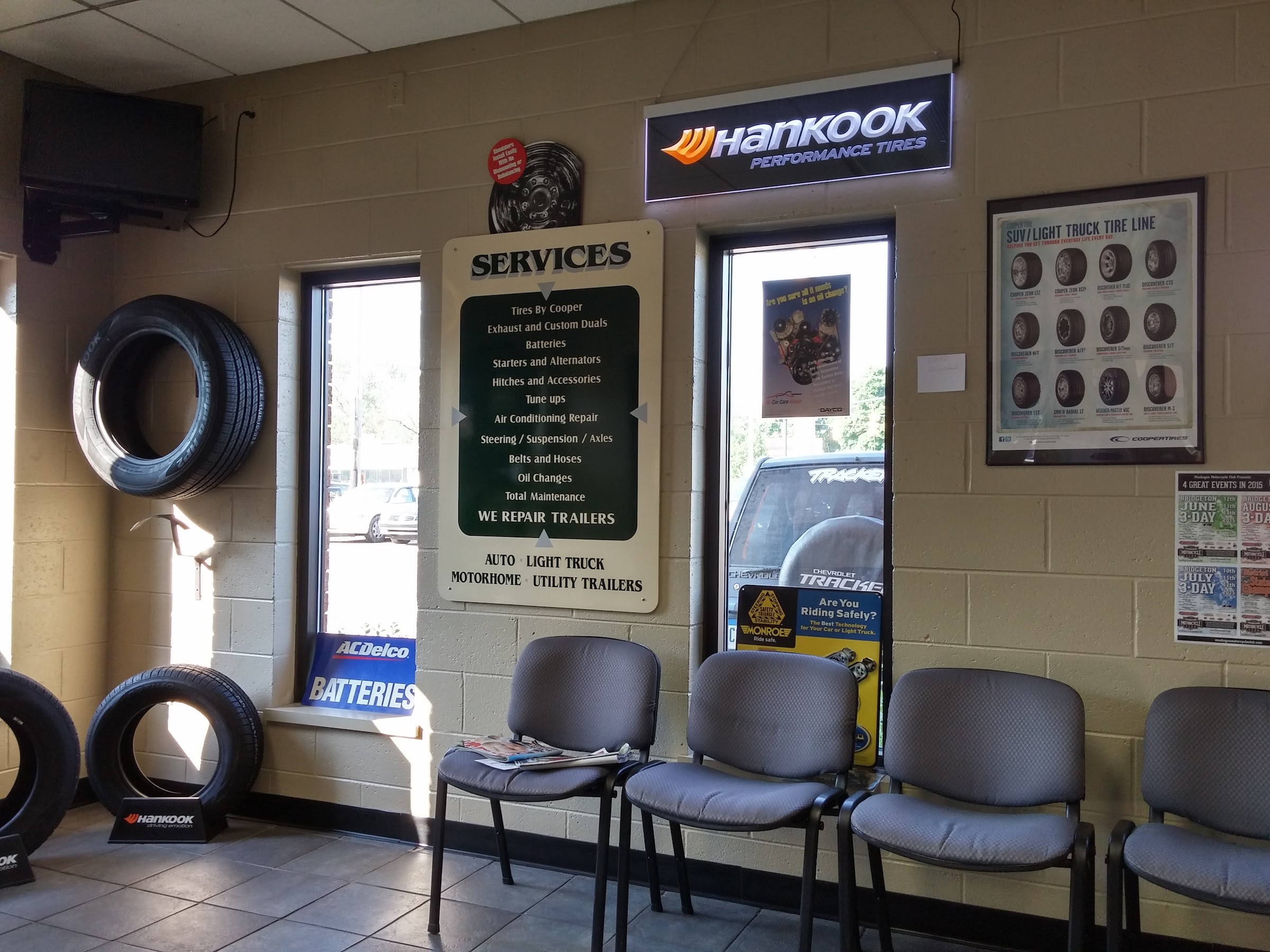 Inside Parker — the full services board, tire wall, and Hankook and ACDelco signage in the waiting room on Burton Street